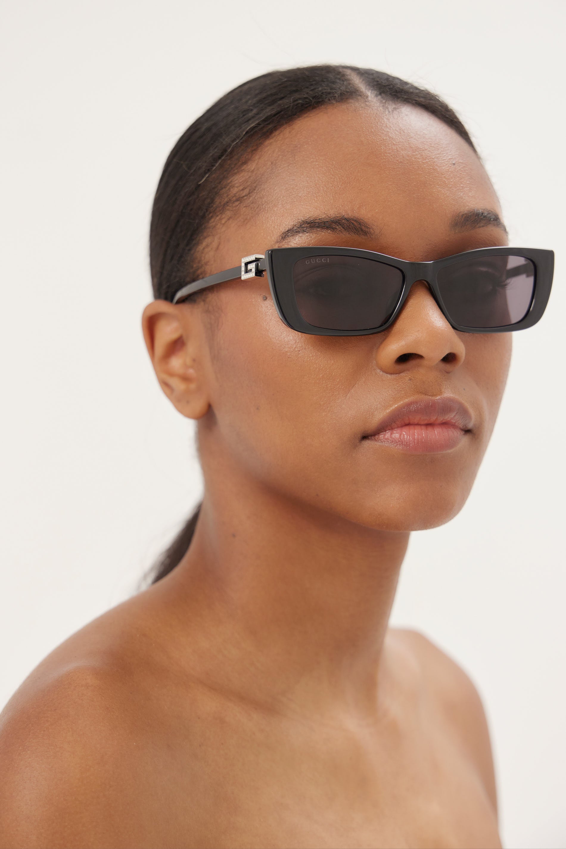 Black cat-eye Gucci sunglasses with silver logo