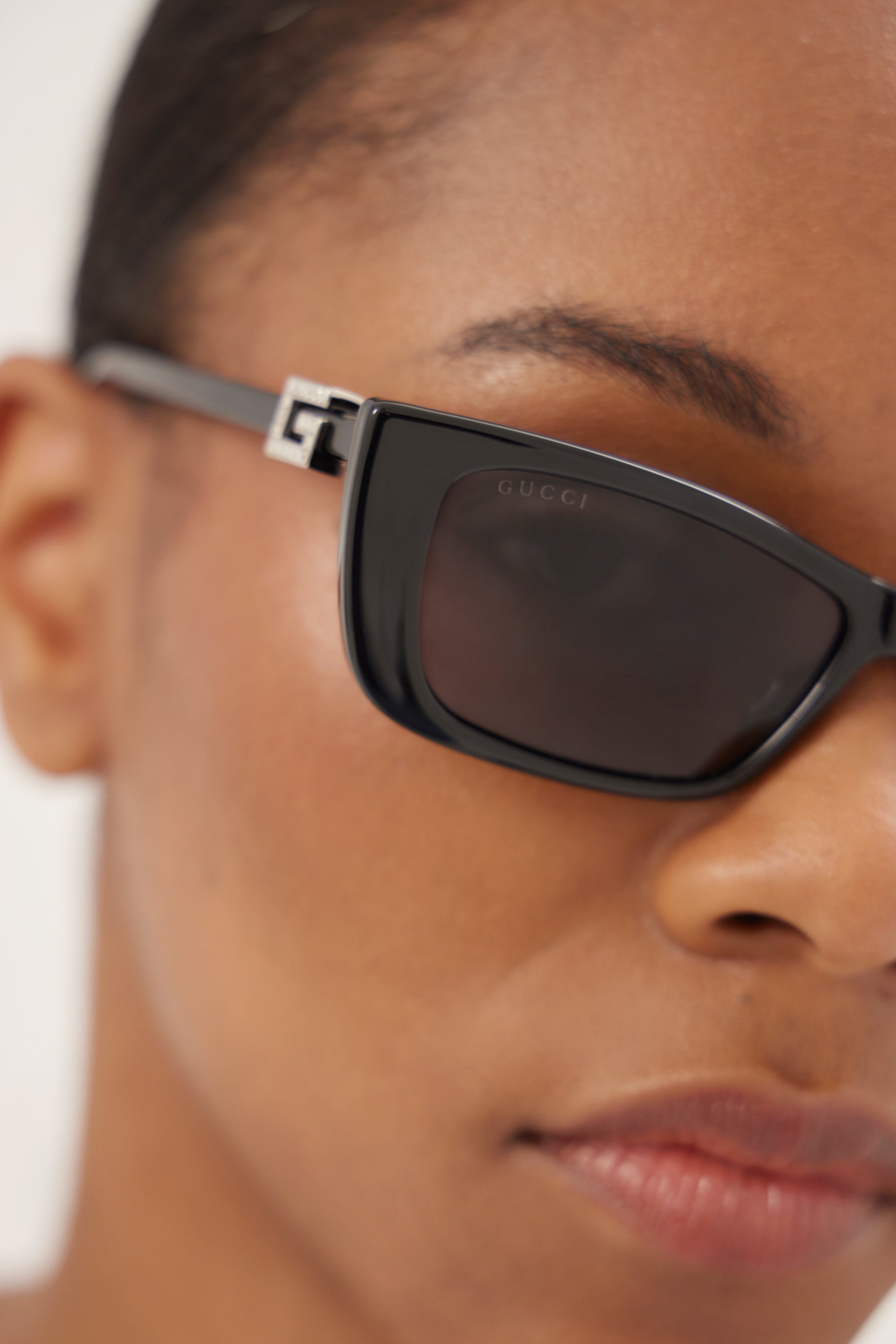 Black cat-eye Gucci sunglasses with silver logo