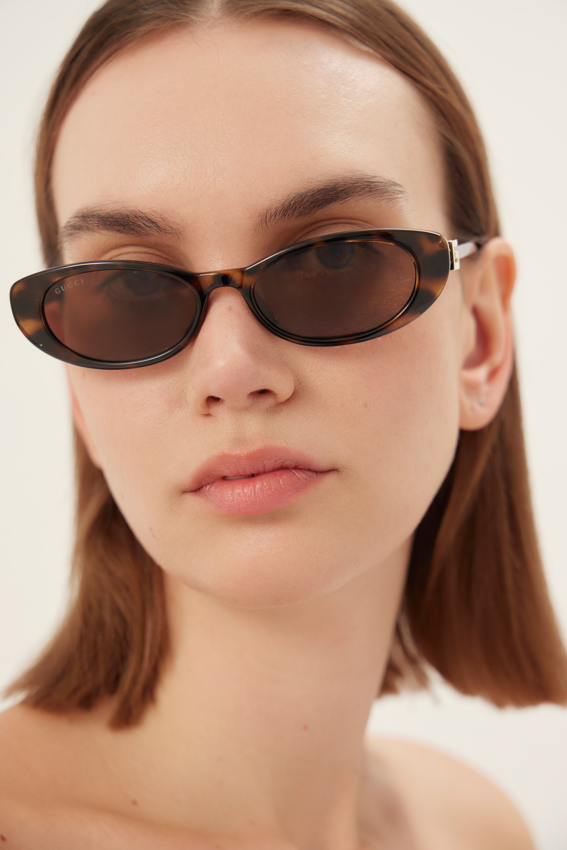 Oval cat-eye havana brown Gucci sunglasses with gold logo